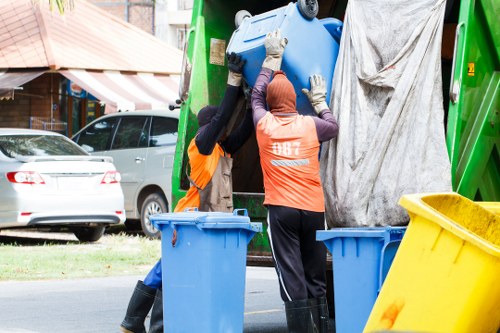 Volunteers sorting donated furniture and garden items for charity reuse