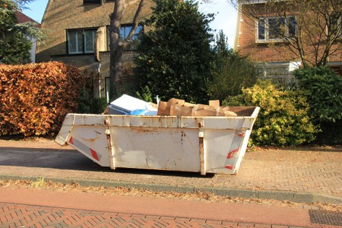 Man and van loading garden waste in a suburban Yiewsley driveway